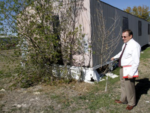 Condemned mobile home, house set for demolition